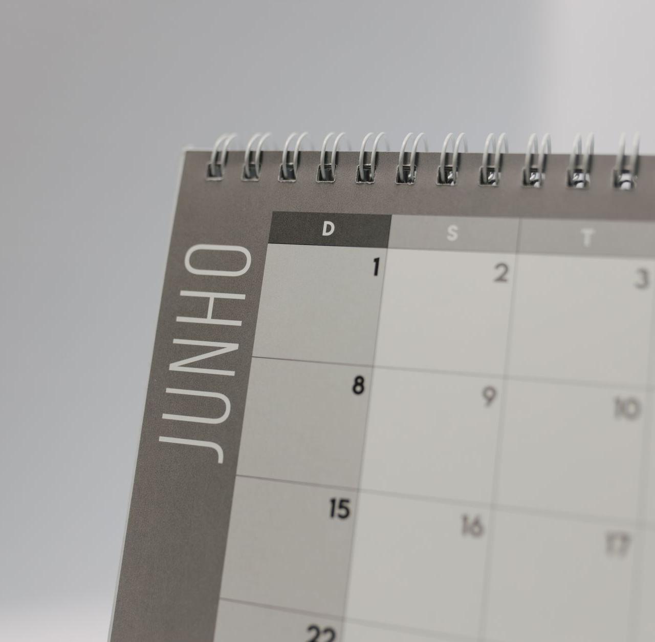 Close-up view of a spiral-bound calendar showing the month of June with a date grid.