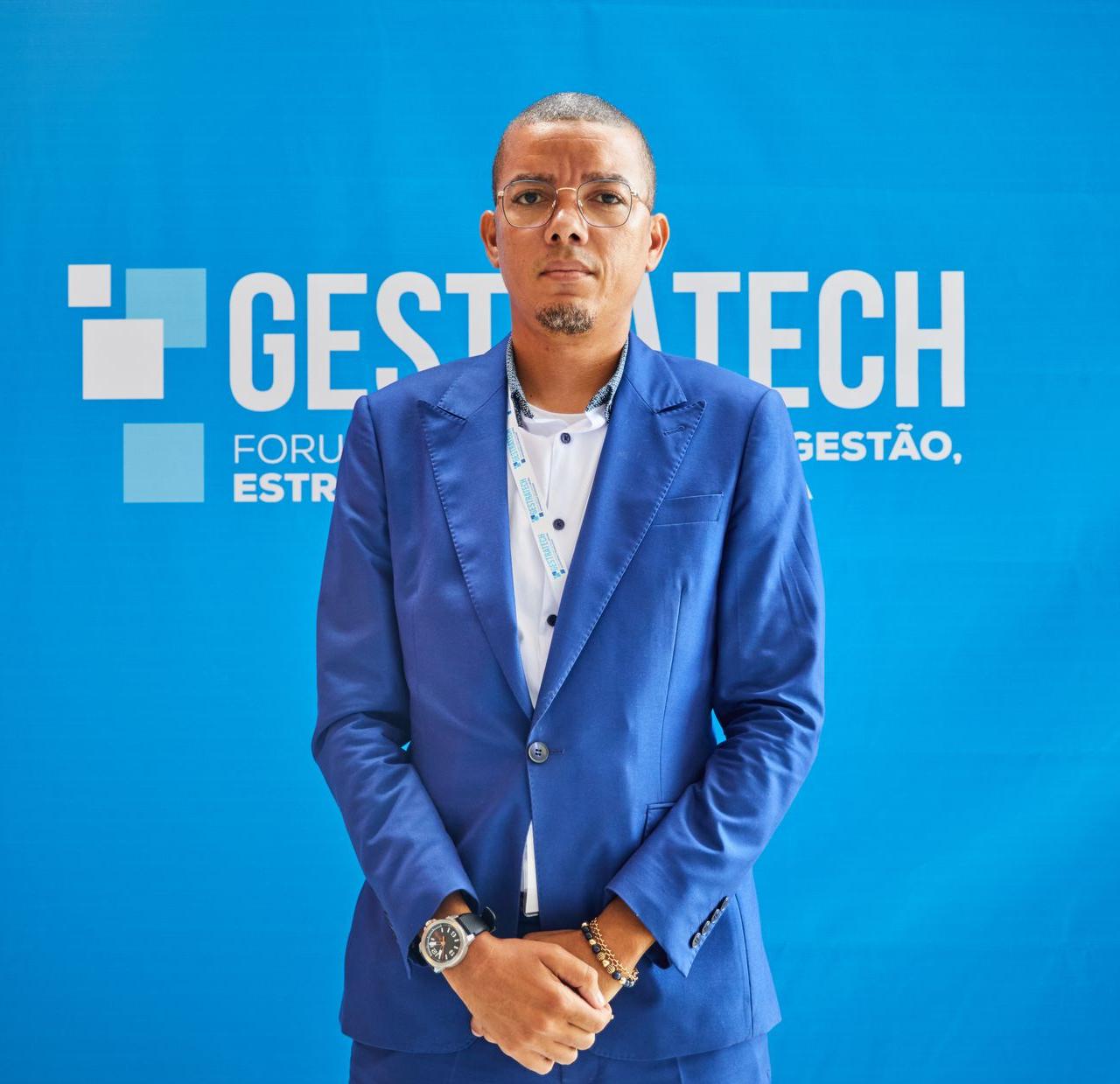Confident businessman in blue suit at a professional conference event.