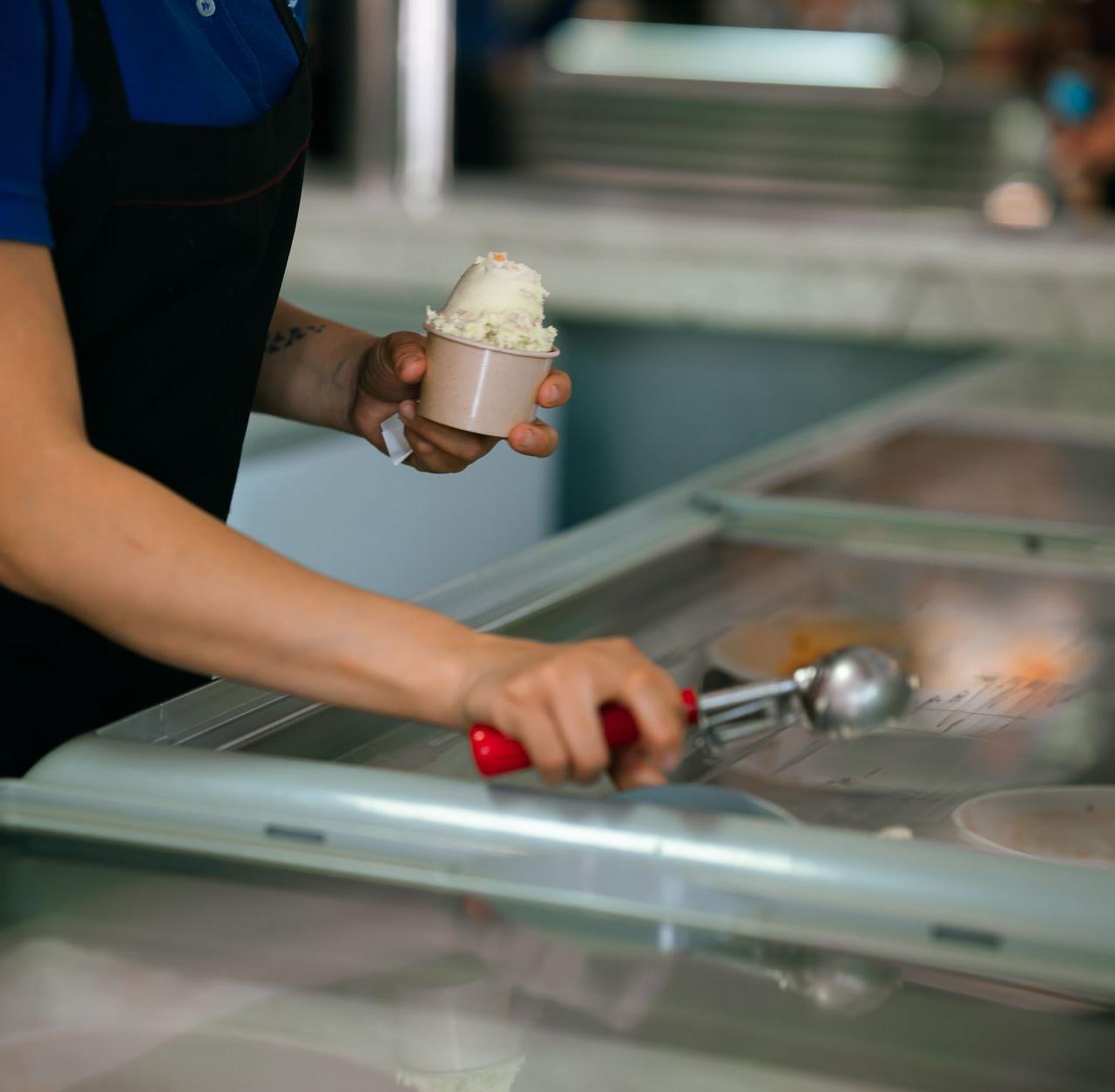 Close-up of a person serving ice cream in a shop in Ciudad de México, México.