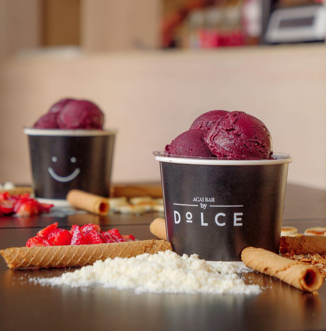 Close-up of a delicious acai bowl with various toppings including fruits and wafers.