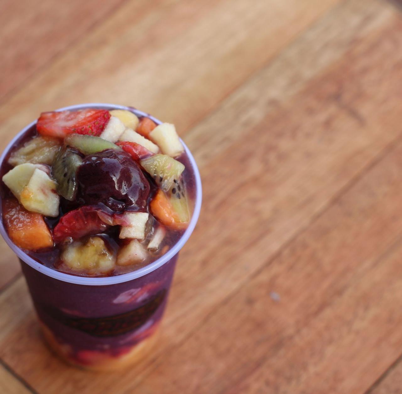 Top view of a vibrant acai bowl topped with fresh fruits, ideal for healthy eating concepts.
